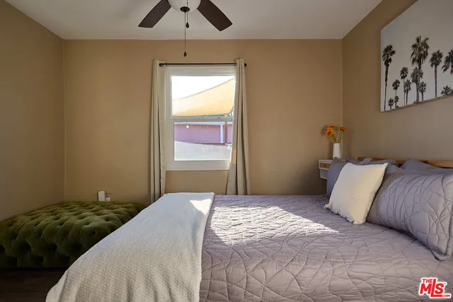 a bedroom with a bed and a window