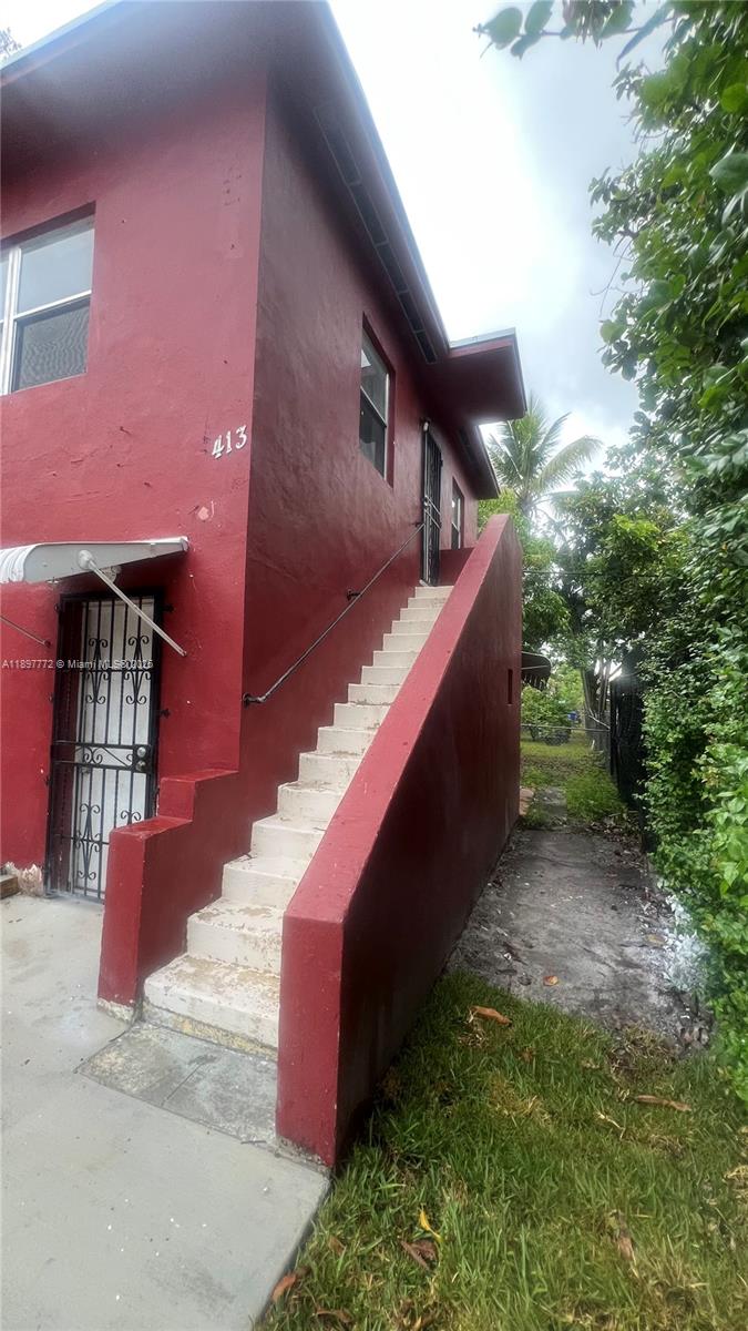 413 Northwest 33rd Street, Unit B Miami, FL 33127 - Photo 1 of 13 a backyard of a house with lots of green space
