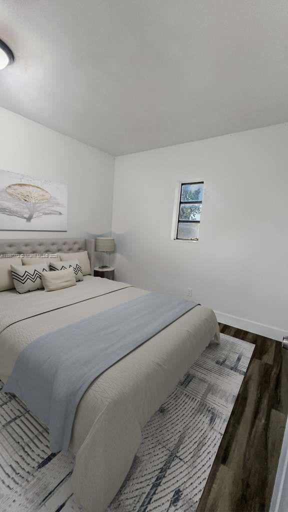 413 Northwest 33rd Street, Unit B Miami, FL 33127 - Photo 13 of 13 a bedroom with a bed and lamp