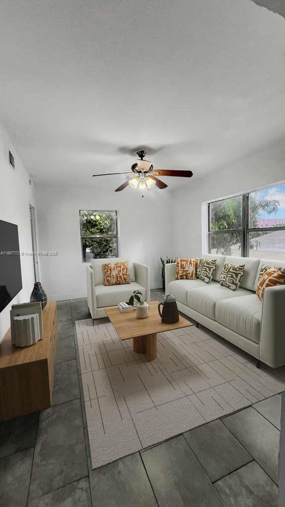 413 Northwest 33rd Street, Unit B Miami, FL 33127 - Photo 2 of 13 a living room with furniture and a chandelier