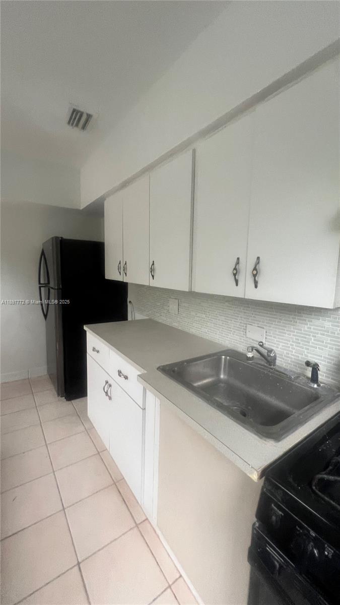 413 Northwest 33rd Street, Unit B Miami, FL 33127 - Photo 3 of 13 a kitchen that has a sink and a stove