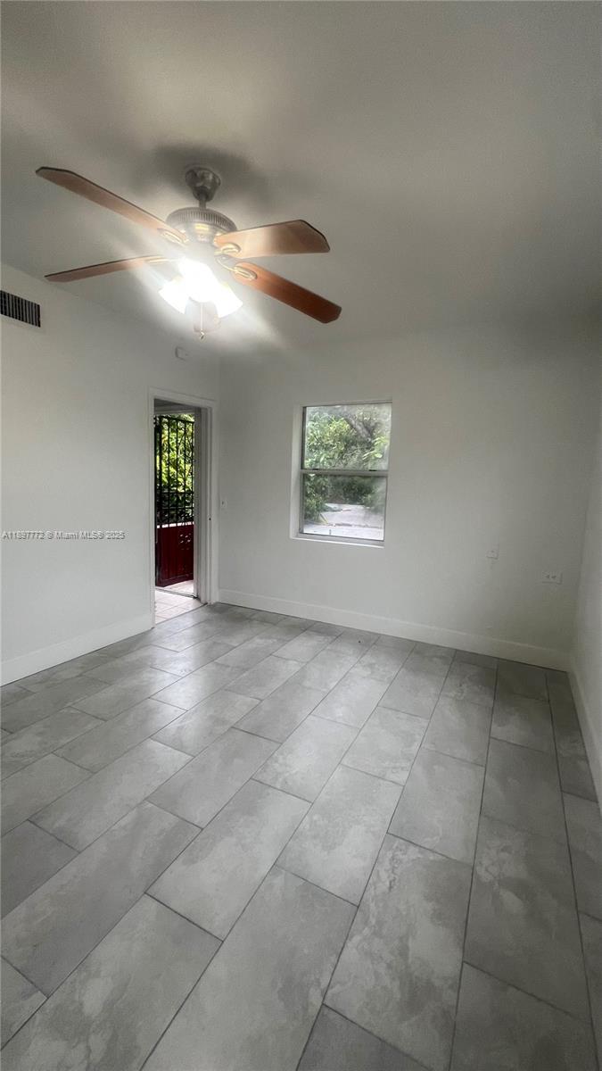 413 Northwest 33rd Street, Unit B Miami, FL 33127 - Photo 5 of 13 a view of an empty room with a window
