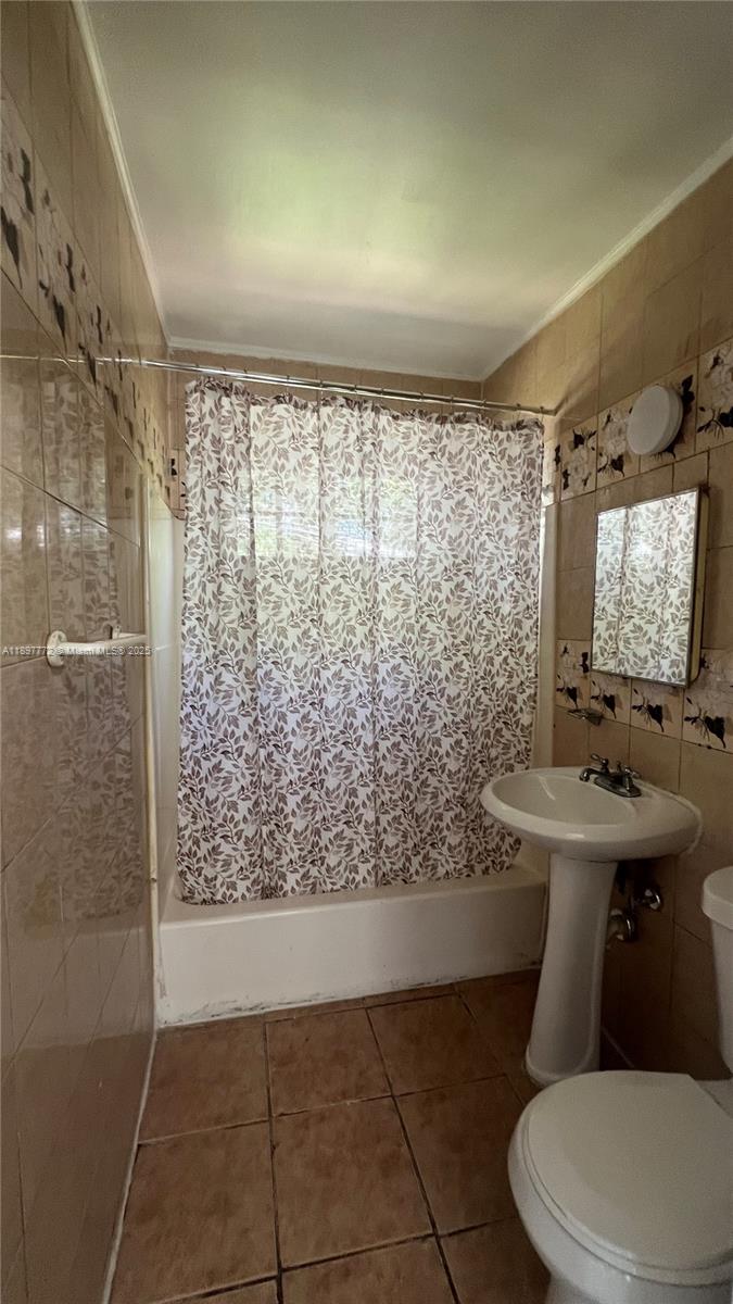 413 Northwest 33rd Street, Unit B Miami, FL 33127 - Photo 8 of 13 a bathroom with a sink toilet and shower