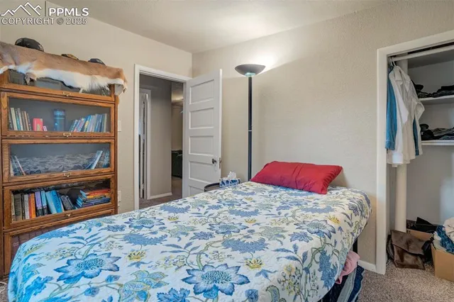 a bedroom with a bed and a book shelf