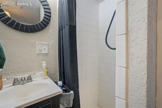a bathroom with a sink and mirror