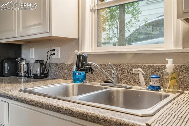 a kitchen sink with granite countertop a sink and a granite counter tops