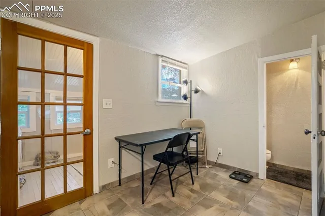 a view of a workspace with furniture and a window