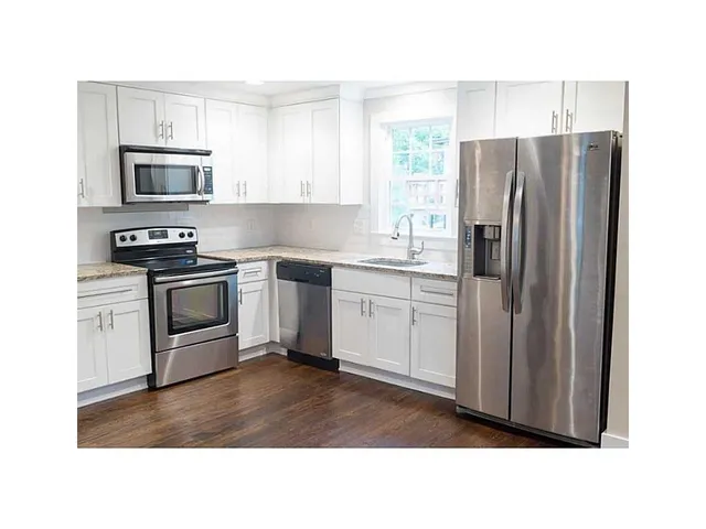 a kitchen with stainless steel appliances a stove a sink microwave and refrigerator