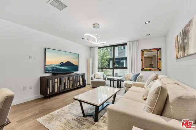 a bedroom with a bed and large window