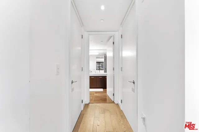 a view of walk in closet with clothes