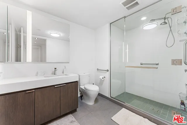 a bedroom with a bed and a flat tv screen