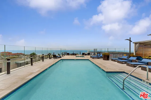 a view of a swimming pool and lounge chair