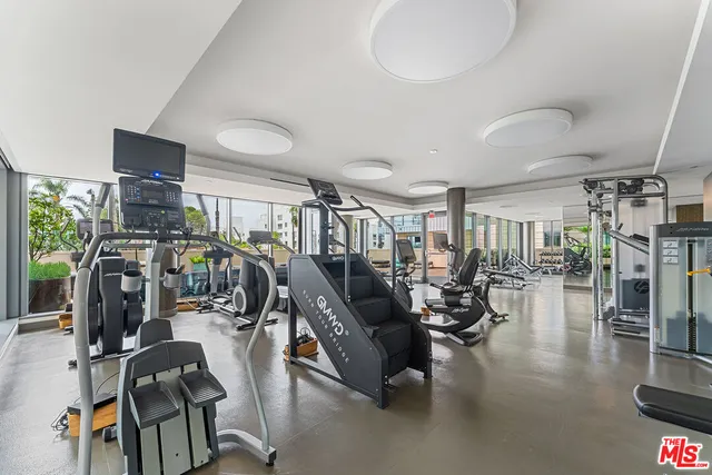 a living room with furniture and kitchen
