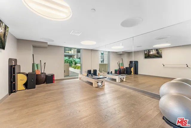 a living room with furniture and floor to ceiling windows
