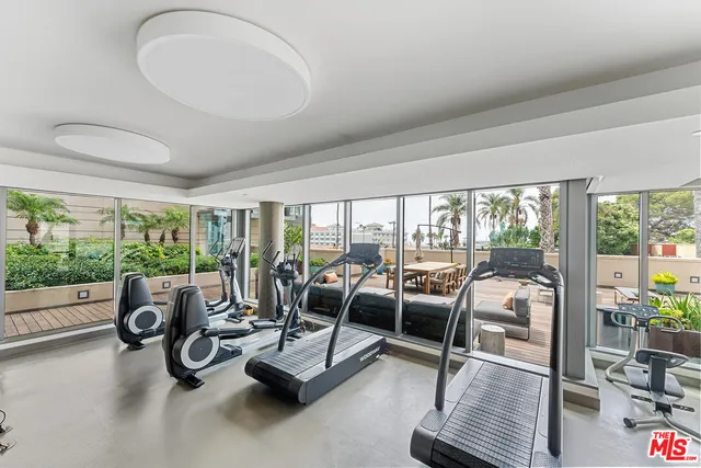 a open kitchen with stainless steel appliances kitchen island granite countertop a stove top oven a sink with dining table and chairs