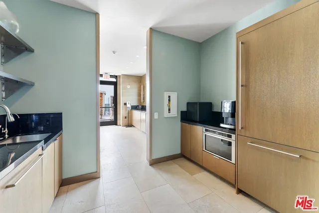 a kitchen with stainless steel appliances a sink and a refrigerator