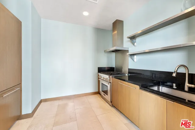a view of a patio with table and chairs potted plants