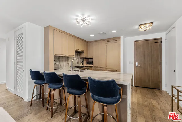 a kitchen with a stove sink and cabinets