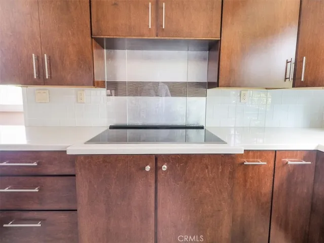 a kitchen with wooden cabinets and a sink