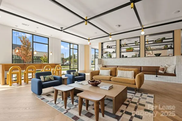 a living room with furniture and large window