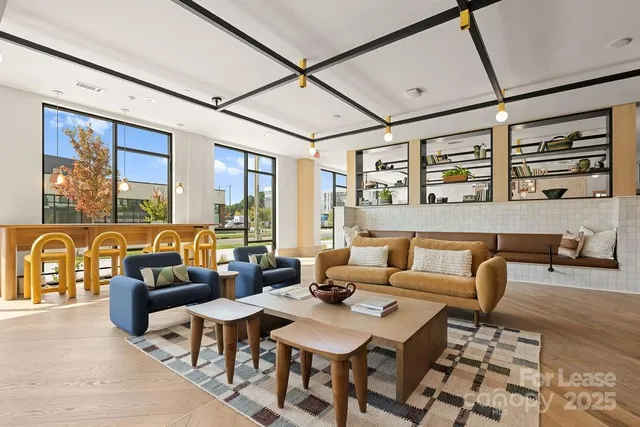 a living room with furniture and large window