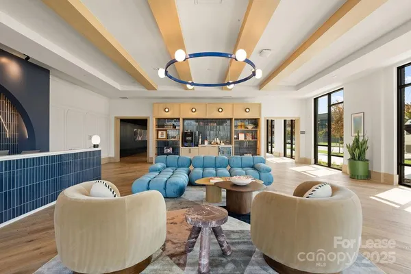 a living room with furniture and a potted plant