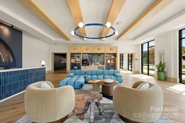 a living room with furniture and a potted plant