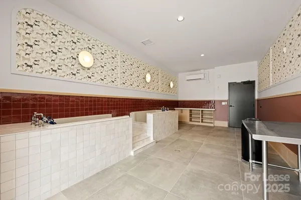 a kitchen with stainless steel appliances cabinets and wooden floor