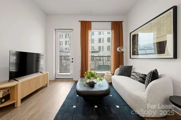 a kitchen with granite countertop a sink appliances and wooden floor