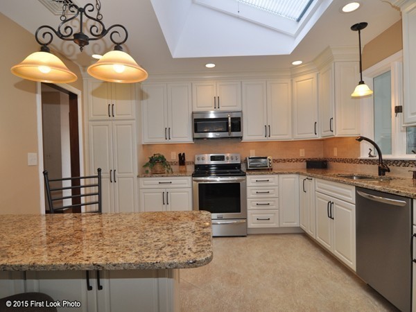 246 Bulgarmarsh Road Tiverton, RI 02878 - Photo 12 of 30 a kitchen with kitchen island granite countertop a stove a sink and a refrigerator