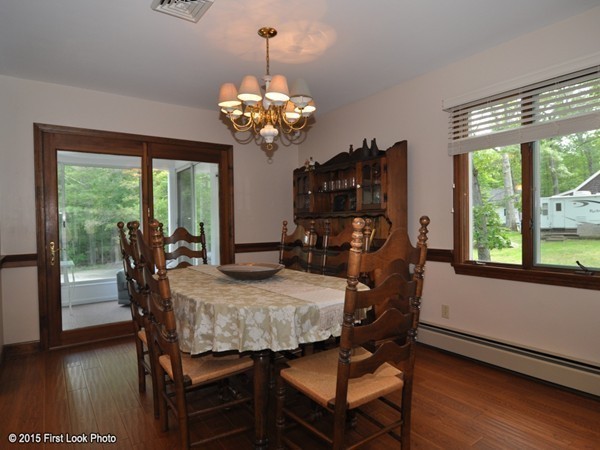 246 Bulgarmarsh Road Tiverton, RI 02878 - Photo 17 of 30 a view of a dining room with furniture a chandelier and wooden floor