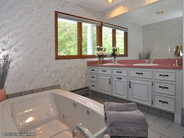 246 Bulgarmarsh Road Tiverton, RI 02878 - Photo 19 of 30 a bathroom with a granite countertop sink a large mirror and a bathtub