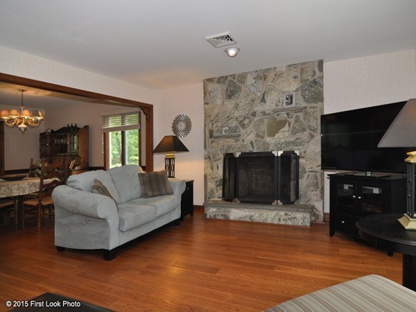 246 Bulgarmarsh Road Tiverton, RI 02878 - Photo 10 of 30 a living room with furniture a flat screen tv and a fireplace