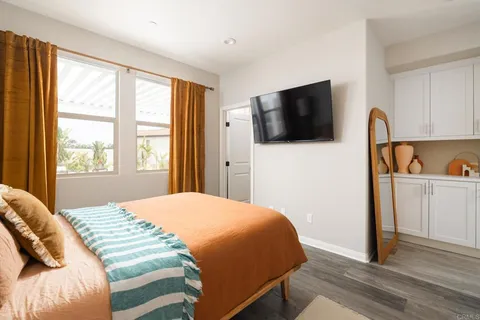 a bedroom with a bed and a flat screen tv