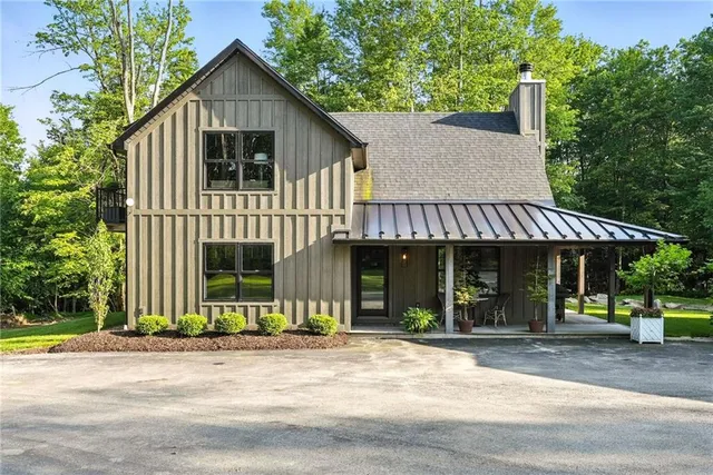 a front view of a house with a garden