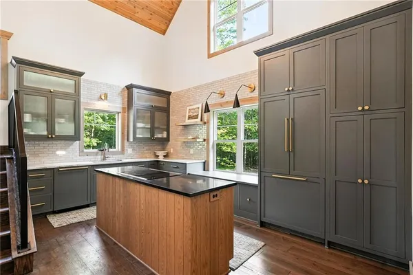 a kitchen with stainless steel appliances granite countertop cabinets and wooden floor