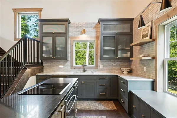 a kitchen that has a sink and a stove