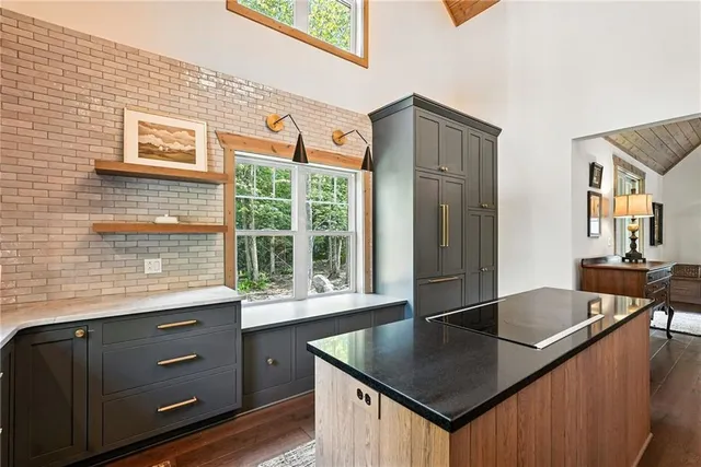 a kitchen with stainless steel appliances granite countertop a sink a stove and a refrigerator