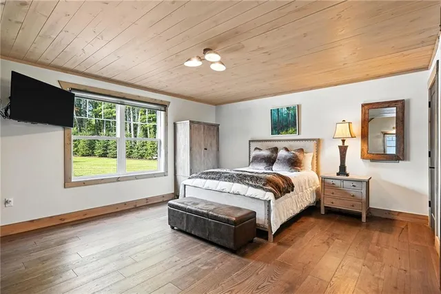 a spacious bedroom with a large bed and a chandelier