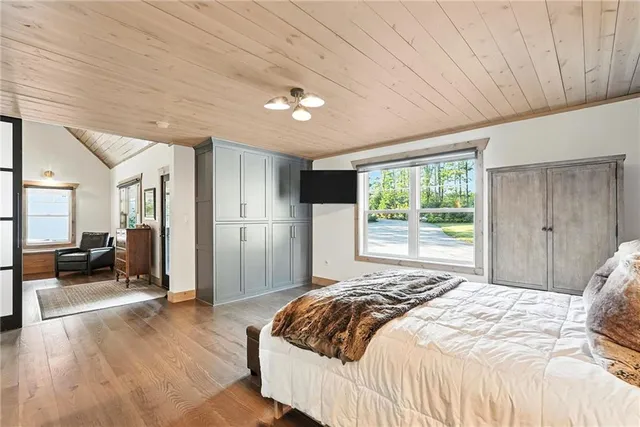 a bedroom with a large bed and a window