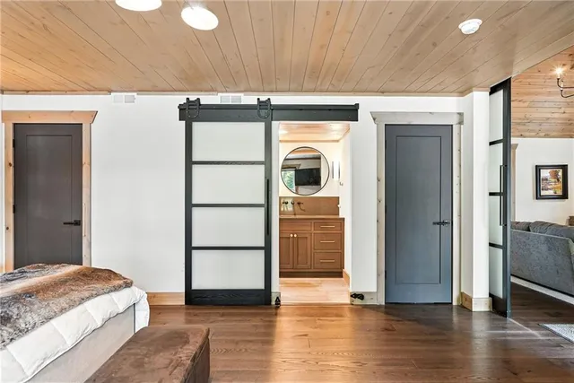 a view of bedroom with a bed and wooden floor