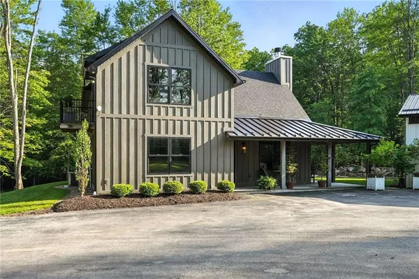 a front view of a house with a garden