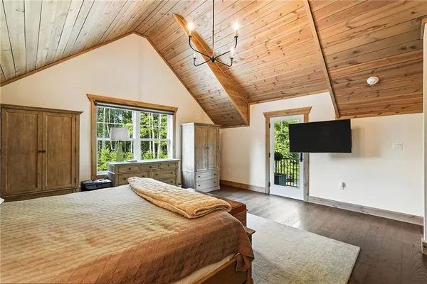 a bedroom with a bed and a television