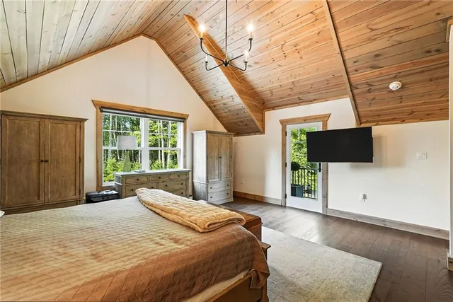 a bedroom with a bed and a television