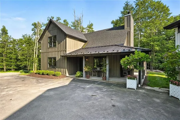 a front view of a house with a garden