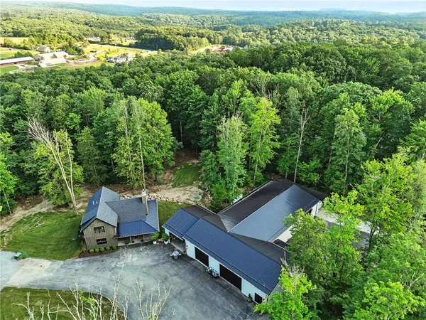 an aerial view of a house with yard and outdoor seating