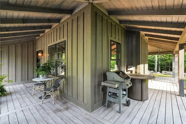 a view of a patio with table and chairs and wooden floor