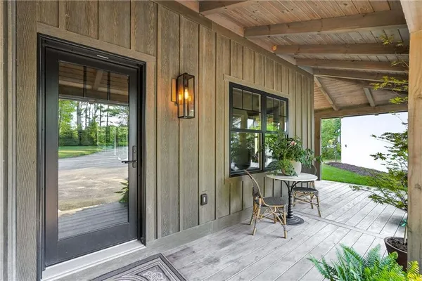 a view of a porch with chairs and backyard