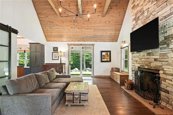 a living room with furniture a flat screen tv and a fireplace