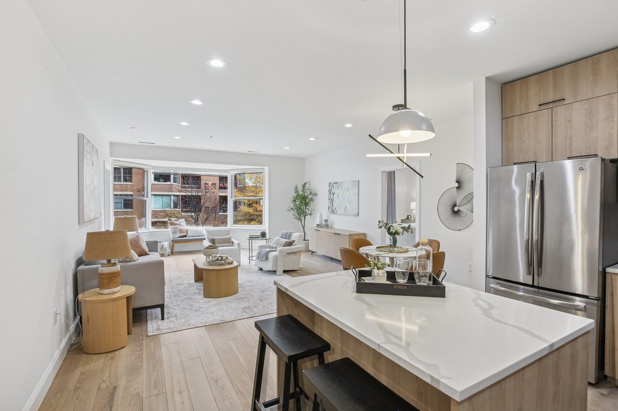 22 Ave At Port Imperial, Unit 208 West New York, NJ 07093 - Photo 12 of 34 a living room with stainless steel appliances furniture a dining table and chairs